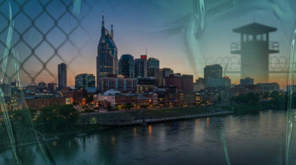 A wide-angle conceptual photograph featuring the Nashville skyline at dusk, overlaid with translucent, greenish-blue gelatinous textures, faint chain-link fence shadows, and symbolic barbed wire elements representing incarceration.